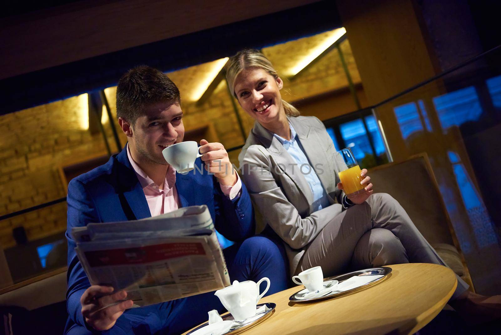 young business people couple relaxing after work in bar restaurant and take drink