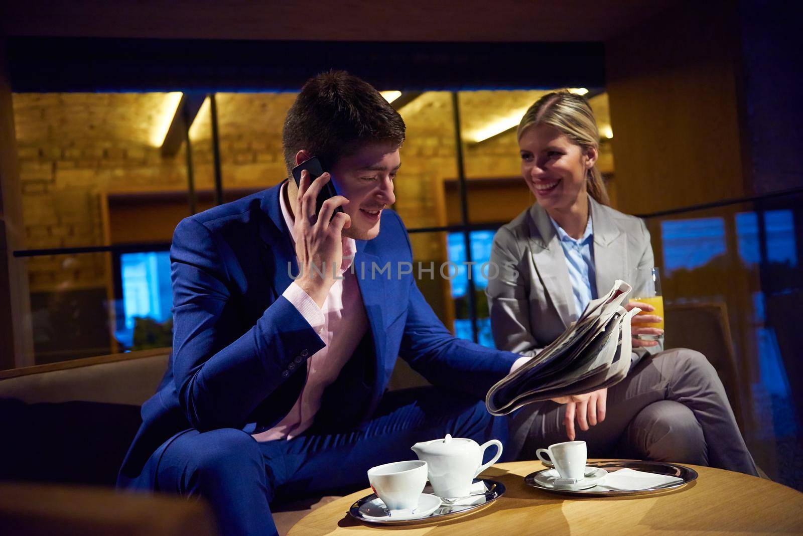 young business people couple relaxing after work in bar restaurant and take drink