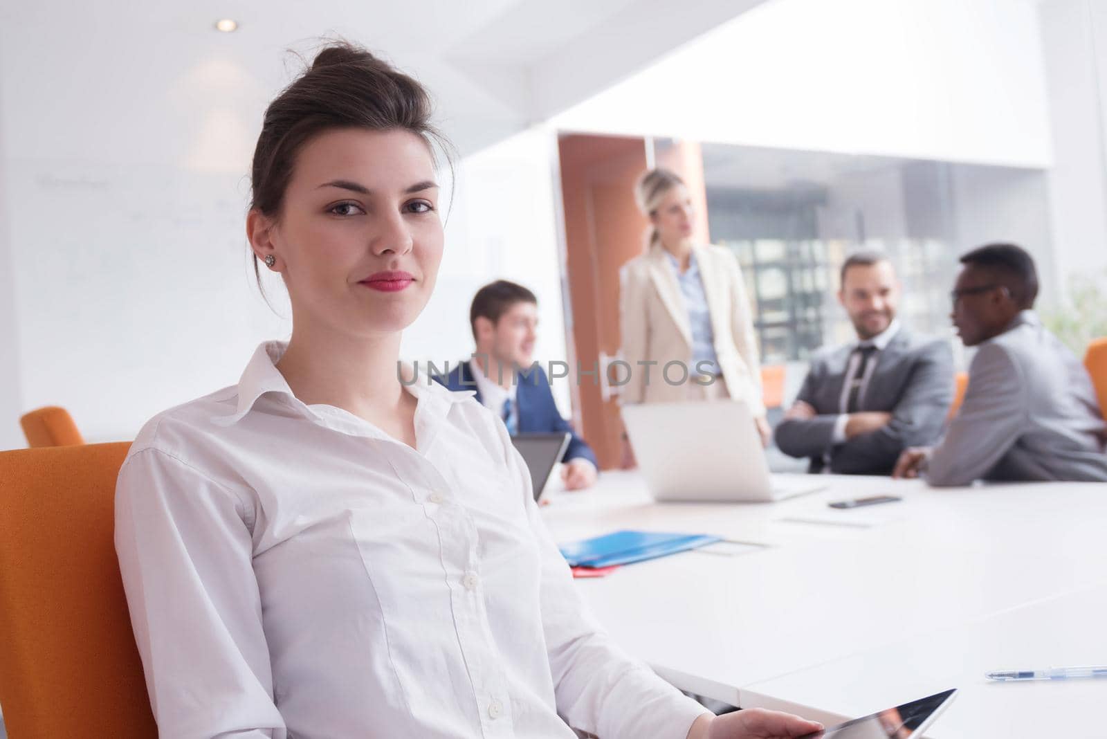 business woman with her staff, people group in background at modern bright office indoors