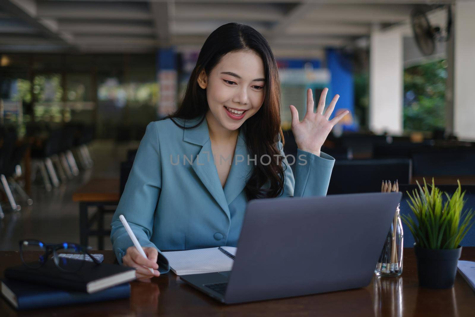 Asian business woman using laptop talk to colleagues for briefing business plan in video call. finance fund investment concept by itchaznong