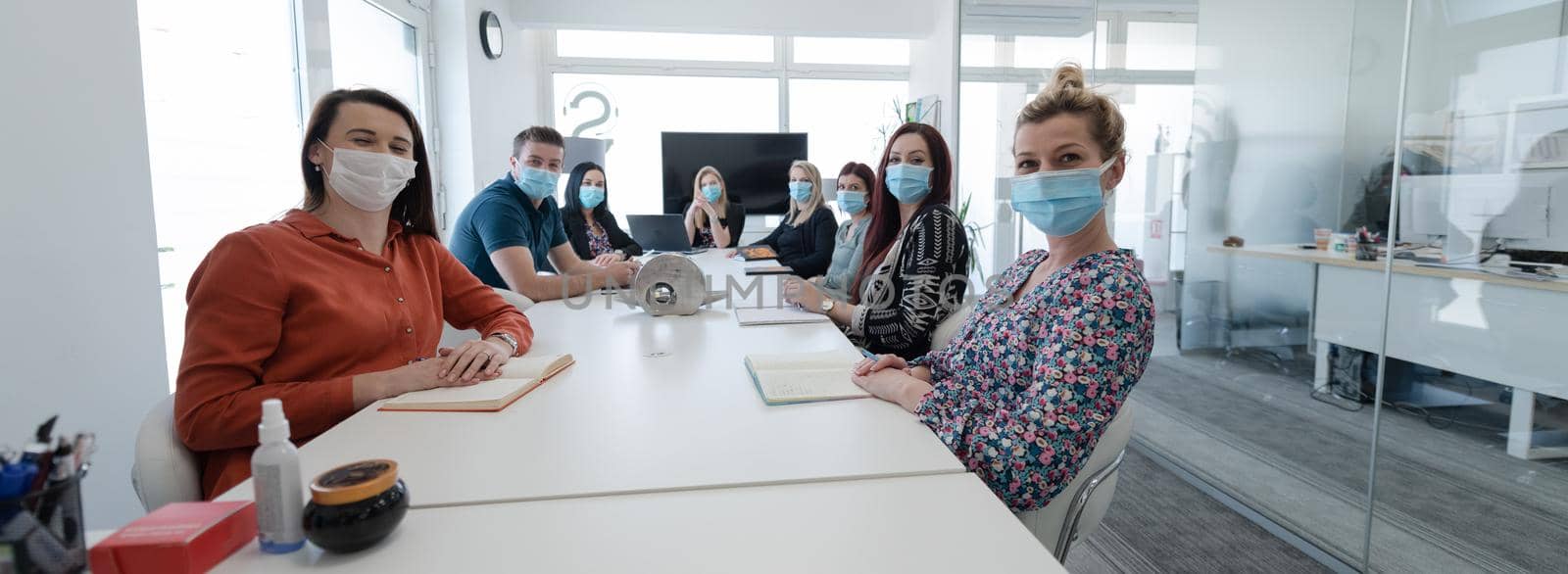 real business people on meeting wearing protective mask by dotshock