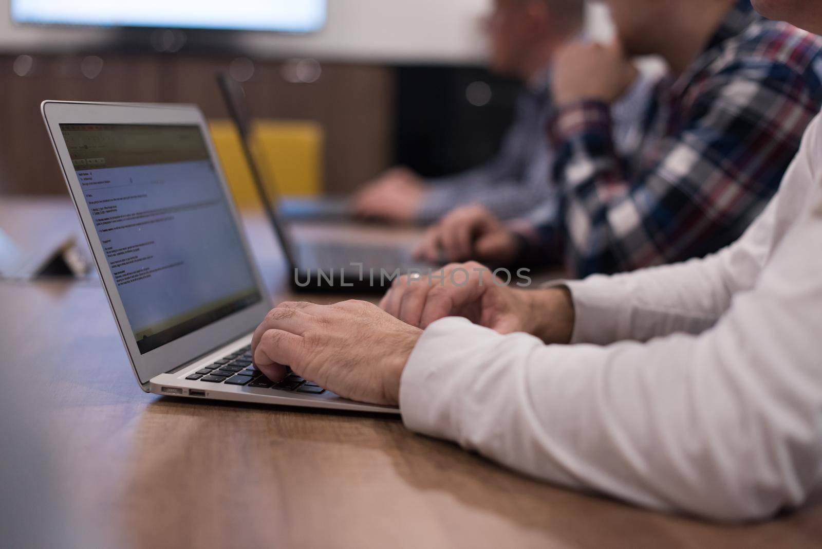 software developer writing programming code on laptop computer