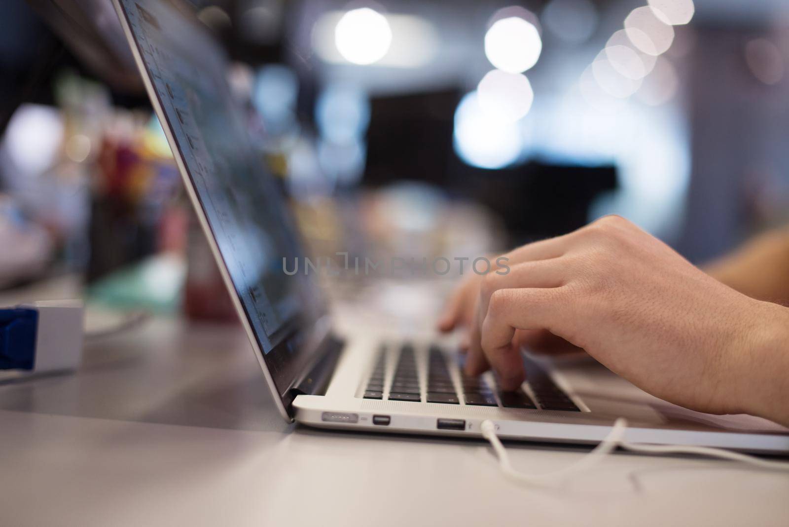 software developer writing programming code on laptop computer