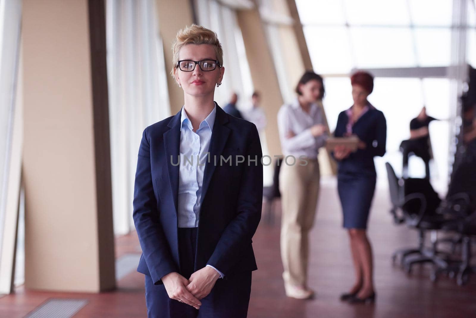 business people group, woman in front  as team leader by dotshock