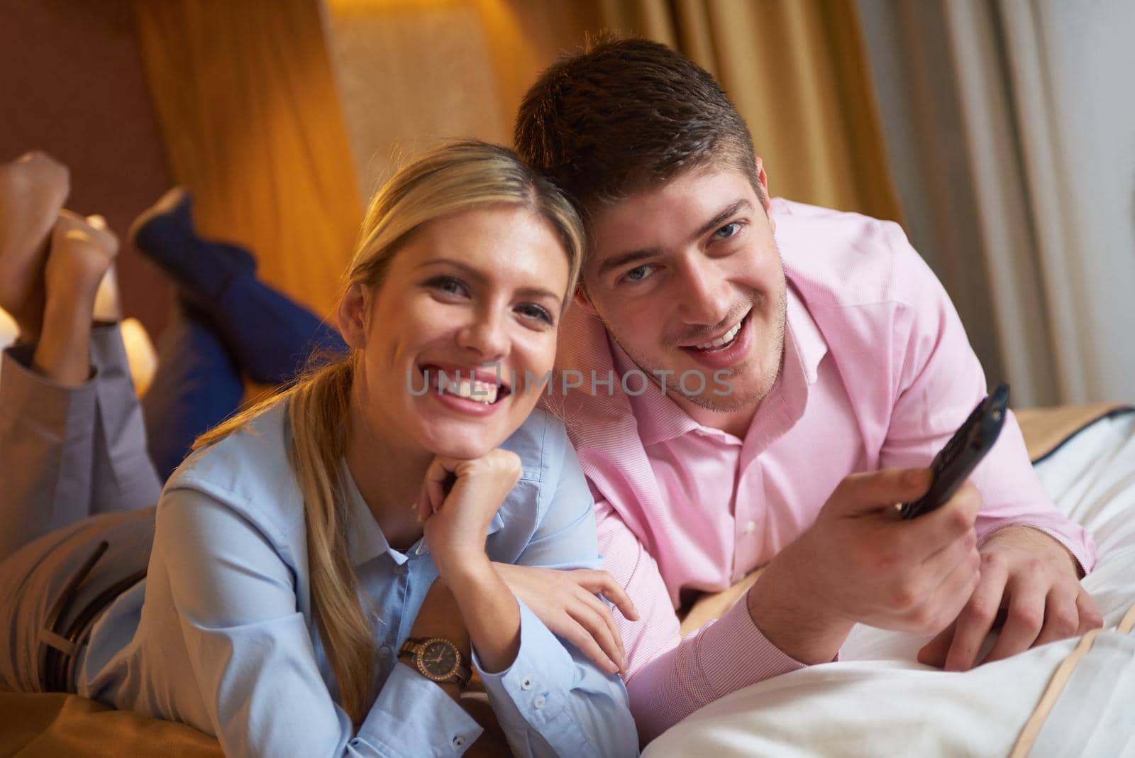 relaxed and happy young couple in modern hotel room