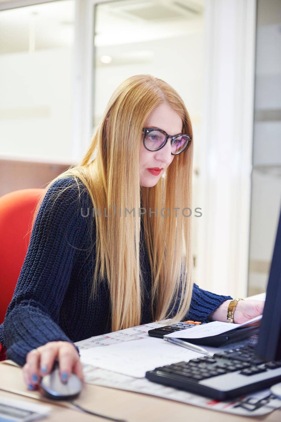 business woman working on computer at office by dotshock