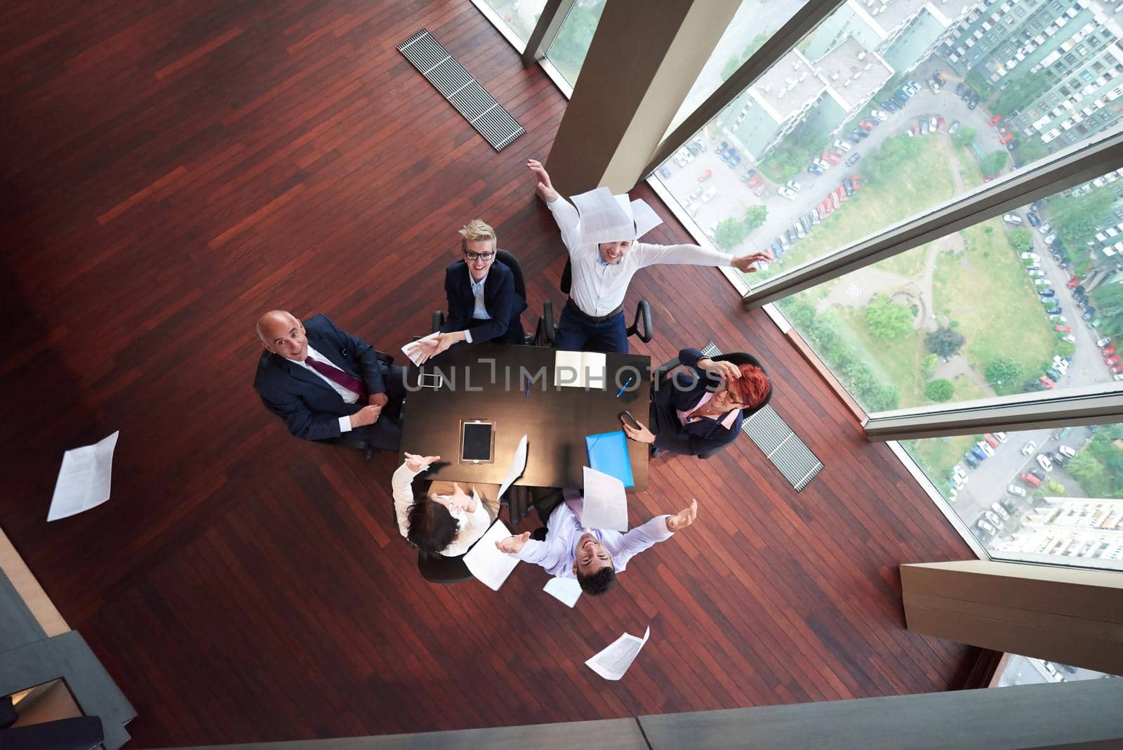 top view of business people group throwing dociments in air by dotshock