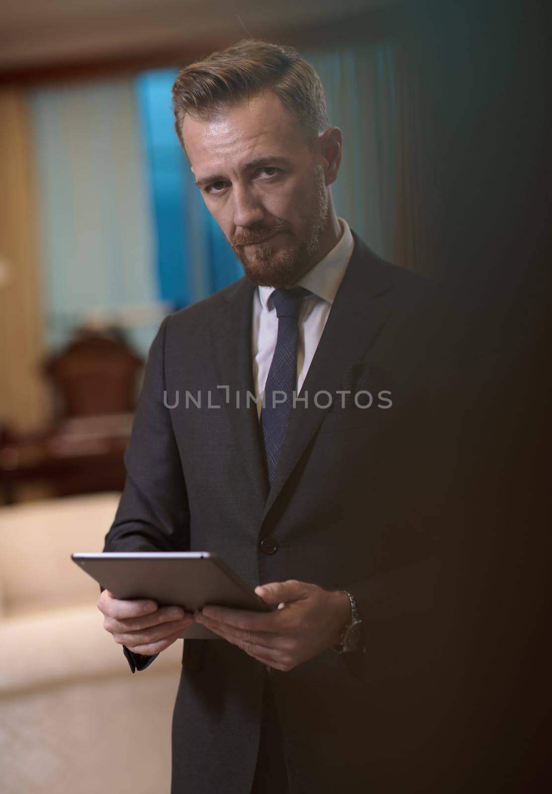 corporate business man using tablet computer in luxury office