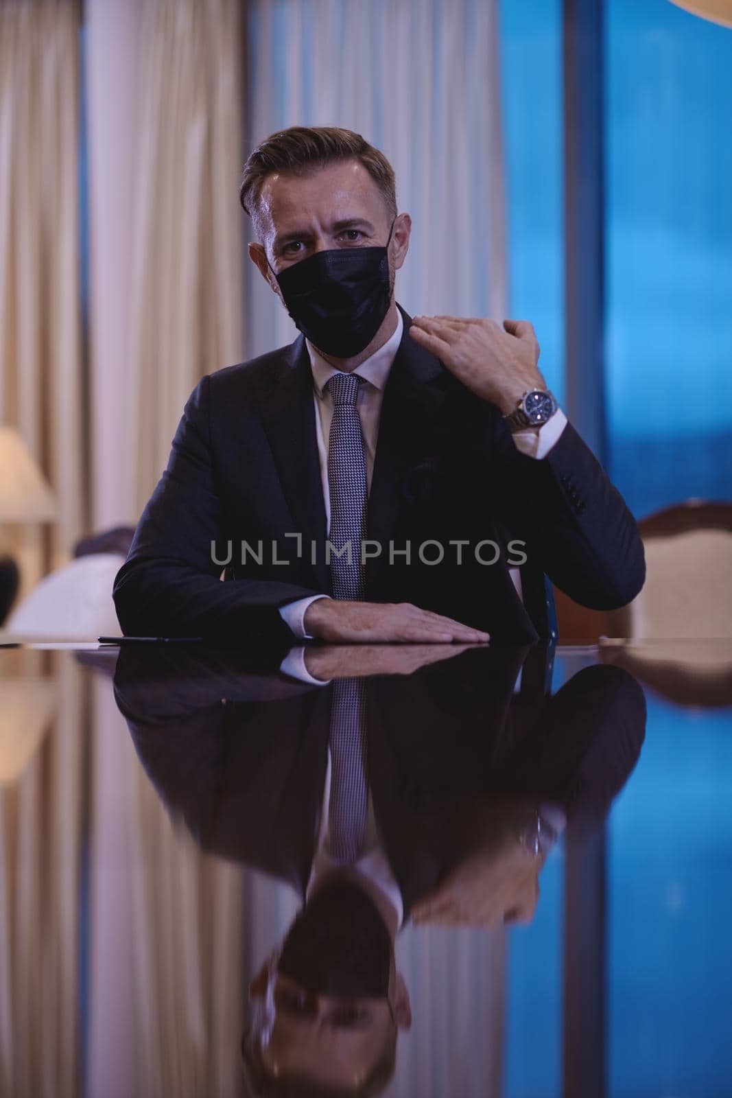 corporate business man wearing protective medical face mask at luxury office