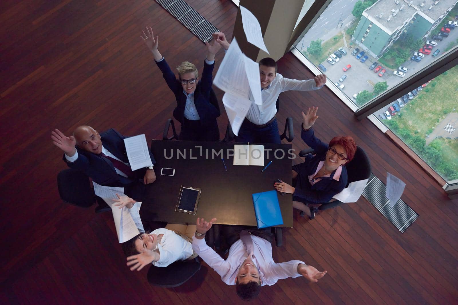 top view of business people group throwing dociments in air by dotshock