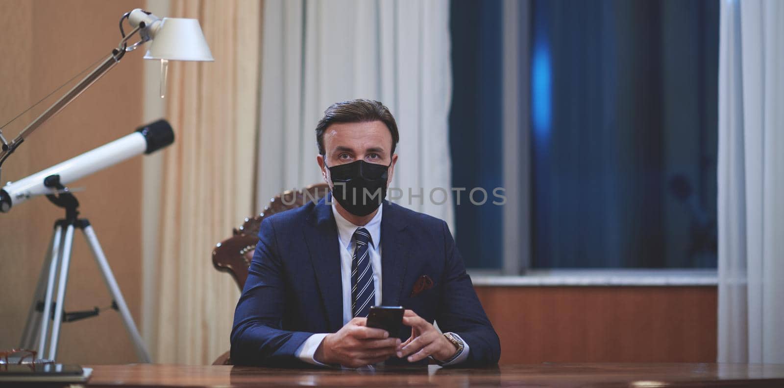 corporate business man wearing protective medical face mask at luxury office