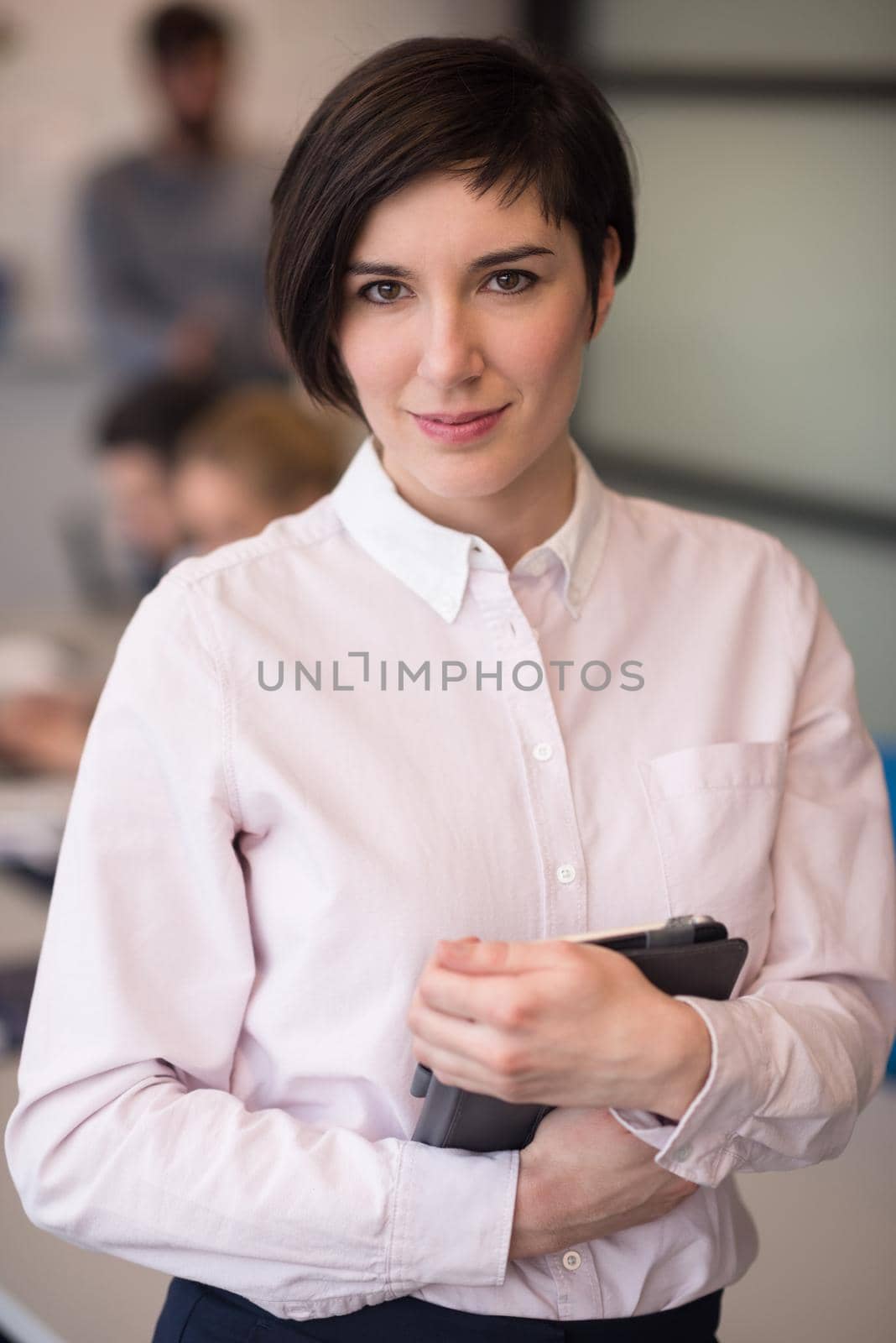 hispanic businesswoman with tablet at meeting room by dotshock