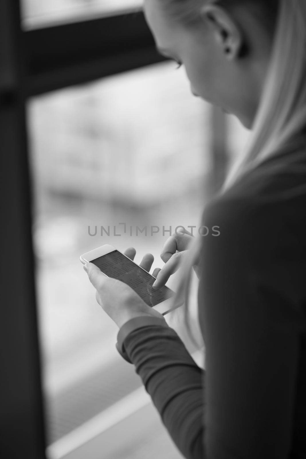 business woman using smart phone at office by dotshock