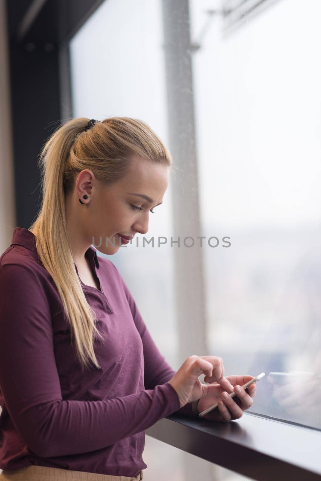 business woman using smart phone at office by dotshock