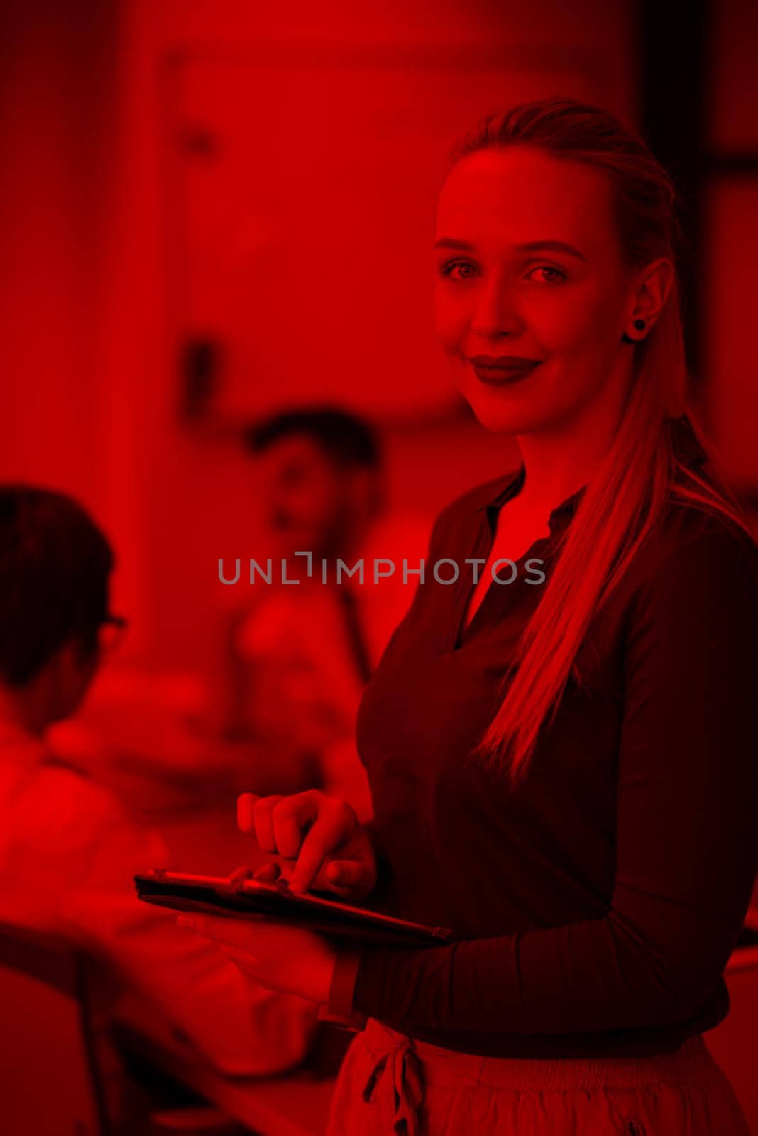 blonde businesswoman working on tablet at office by dotshock