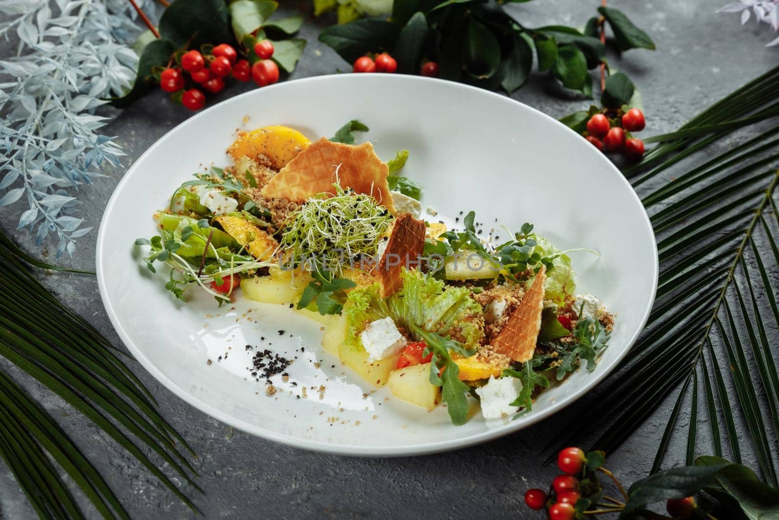 Summer diet salad with leaves of lettuce, watermelon, peach and feta cheese. On a light blue background copy space by UcheaD