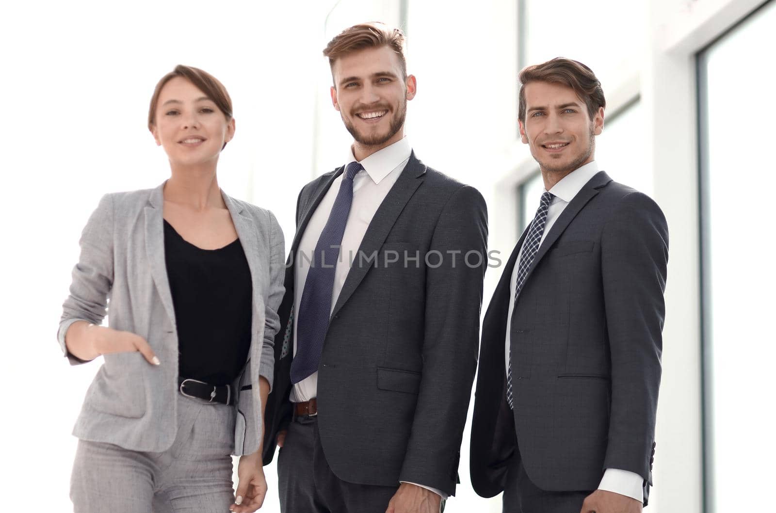 three business colleagues standing in a bright office.photo with copy space