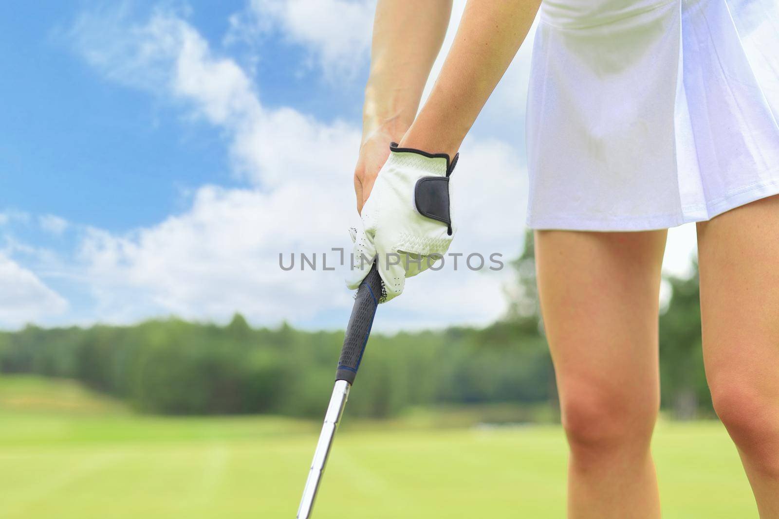 Golfer wearing a golf holding a putter