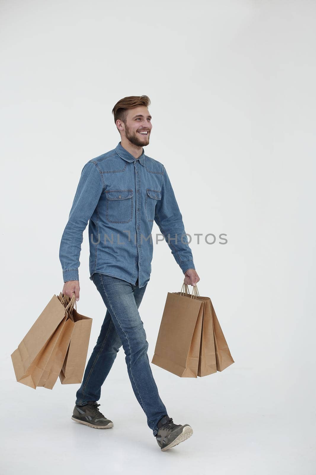 Picture of young slim male with shopping bag on isolated white