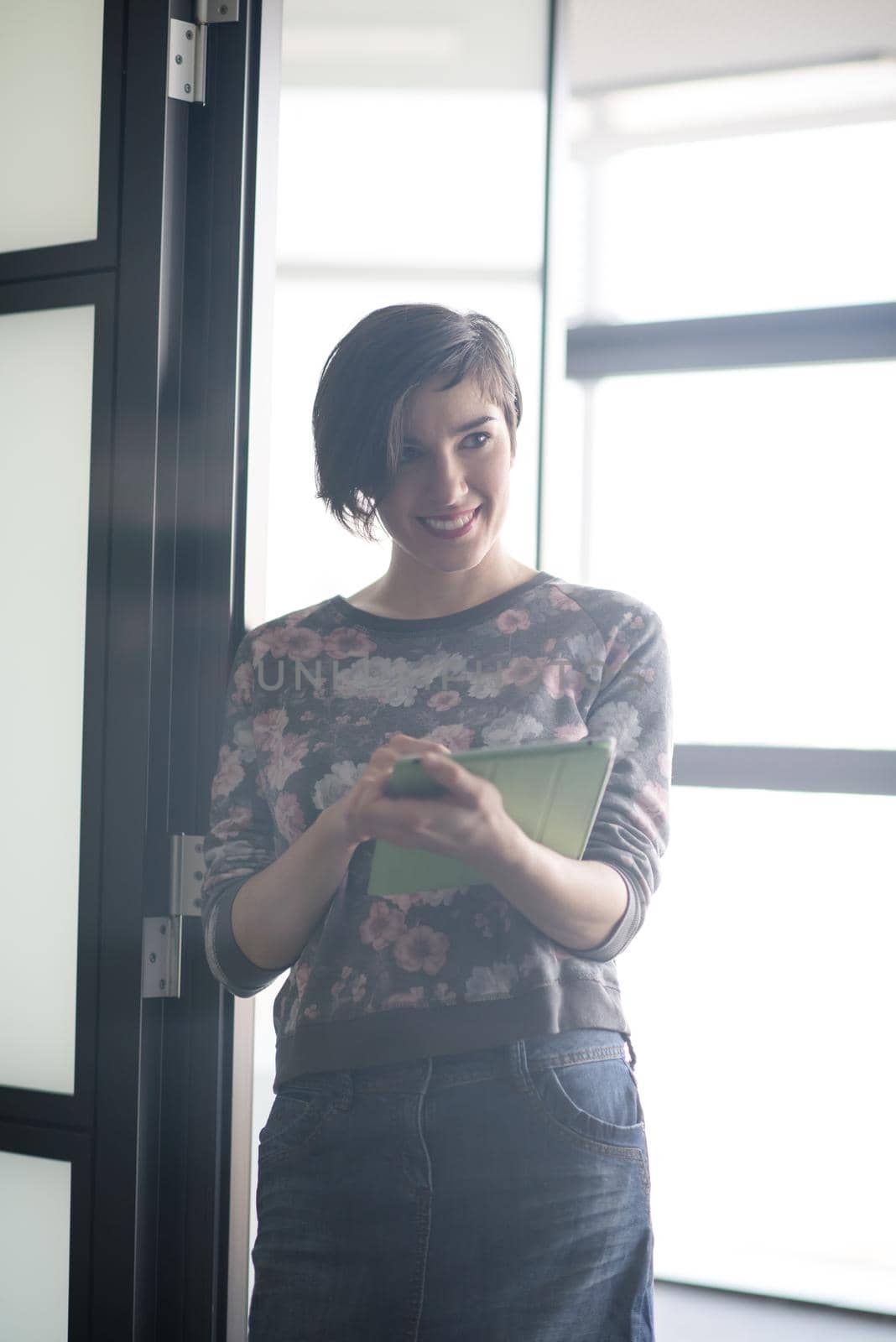 yonug businesswoman in casual hipster clothes working on tablet computer at modern startup business office interior