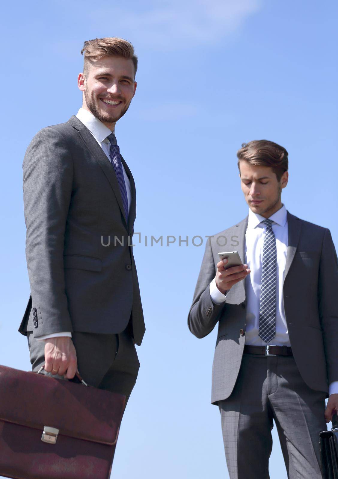 two modern business people standing on the street by asdf