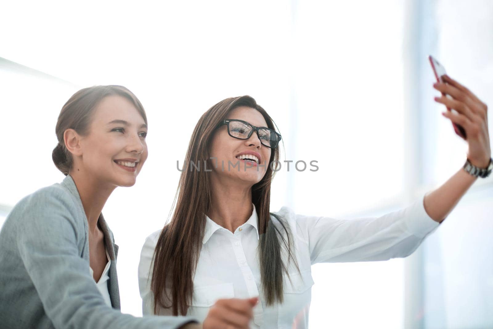 two employees taking a selfie in the workplace.photo with text space