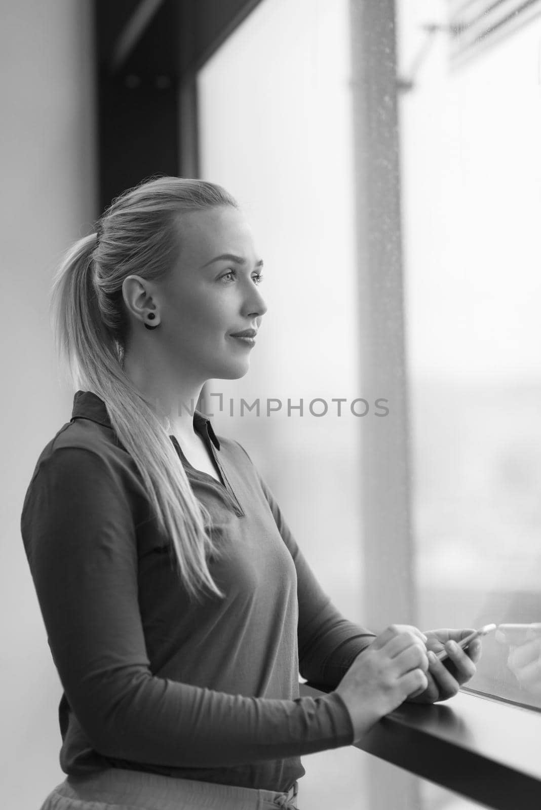 business woman at office using smart phone to surf internet and type messages