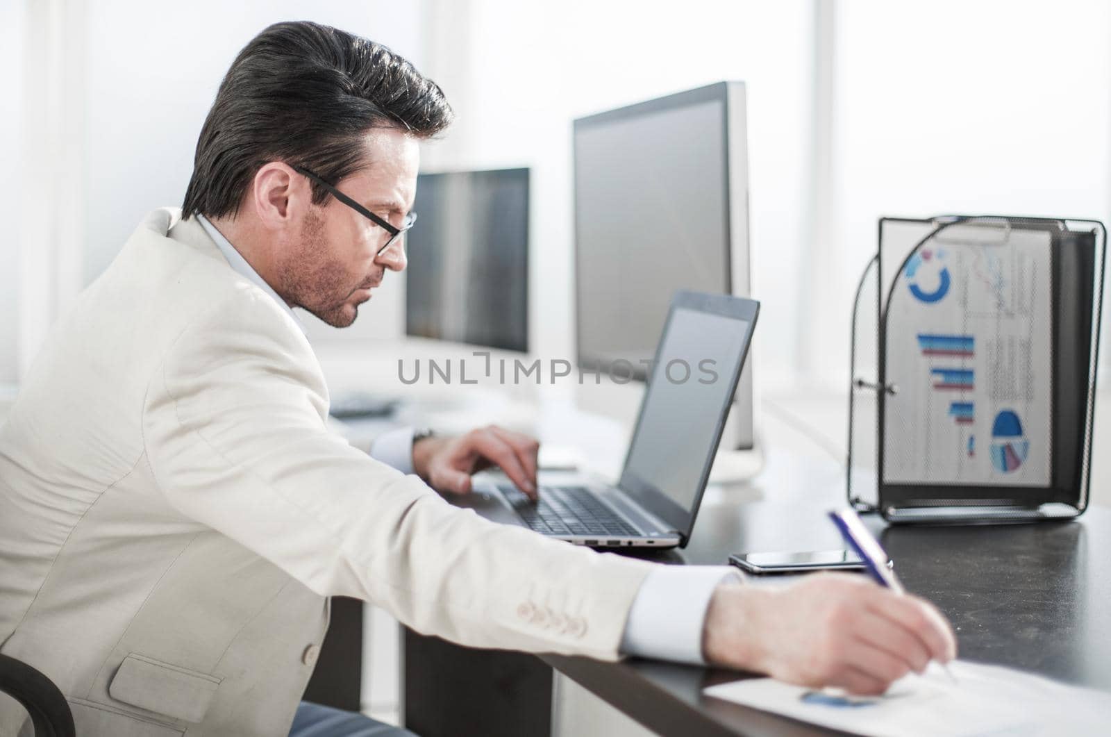 Executive businessman writing down information in a notebook.business concept