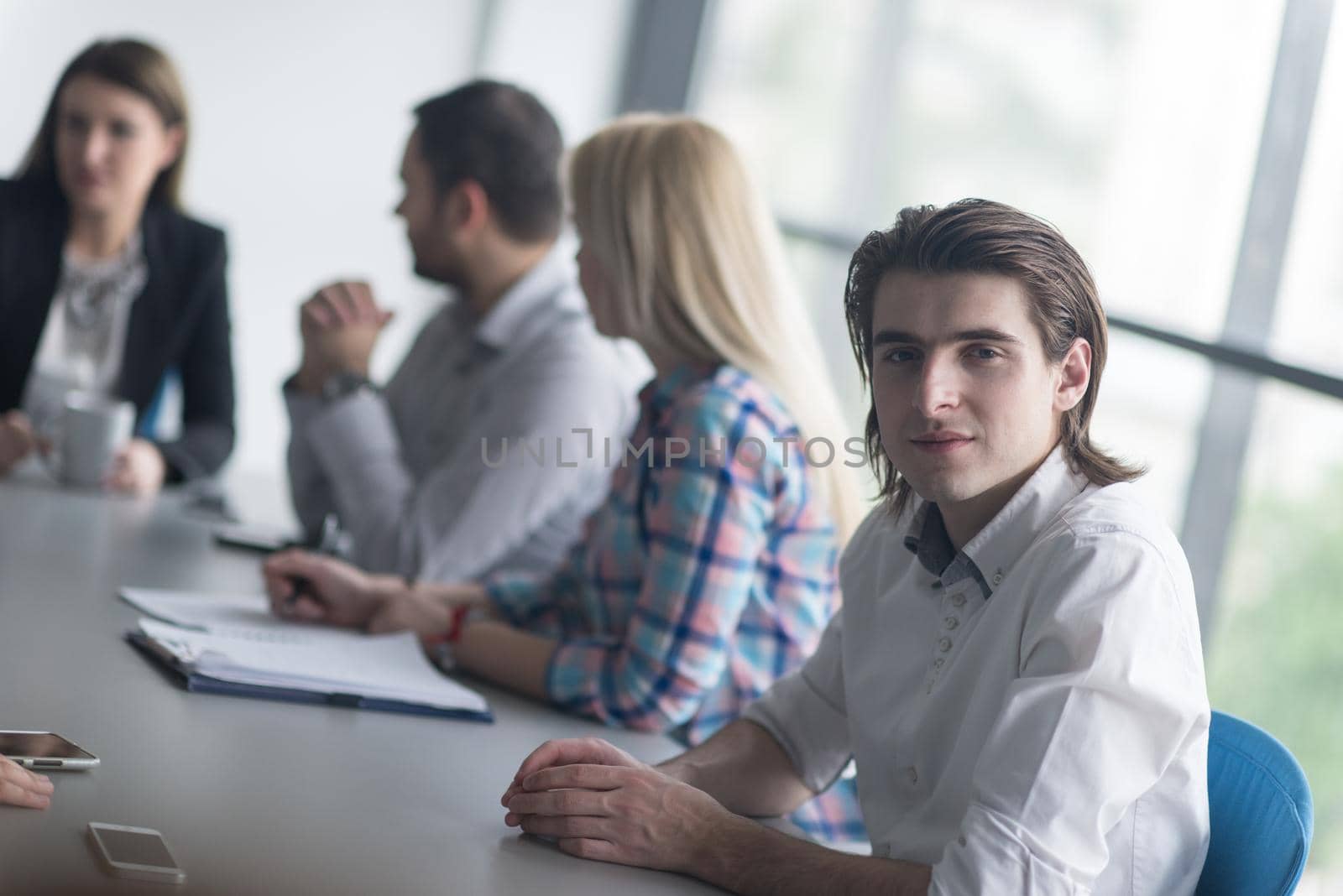 Group of young people meeting in startup office by dotshock