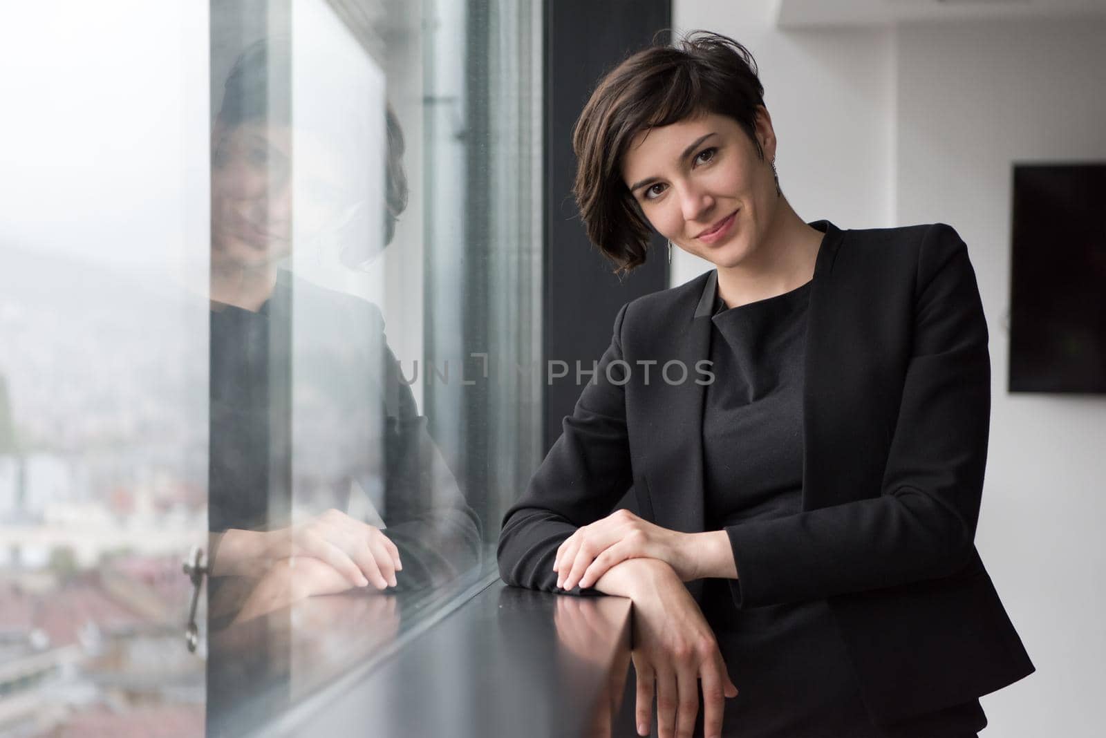 Portrait Of Successful Businesswoman by the window Entrepreneur At Busy startup Office