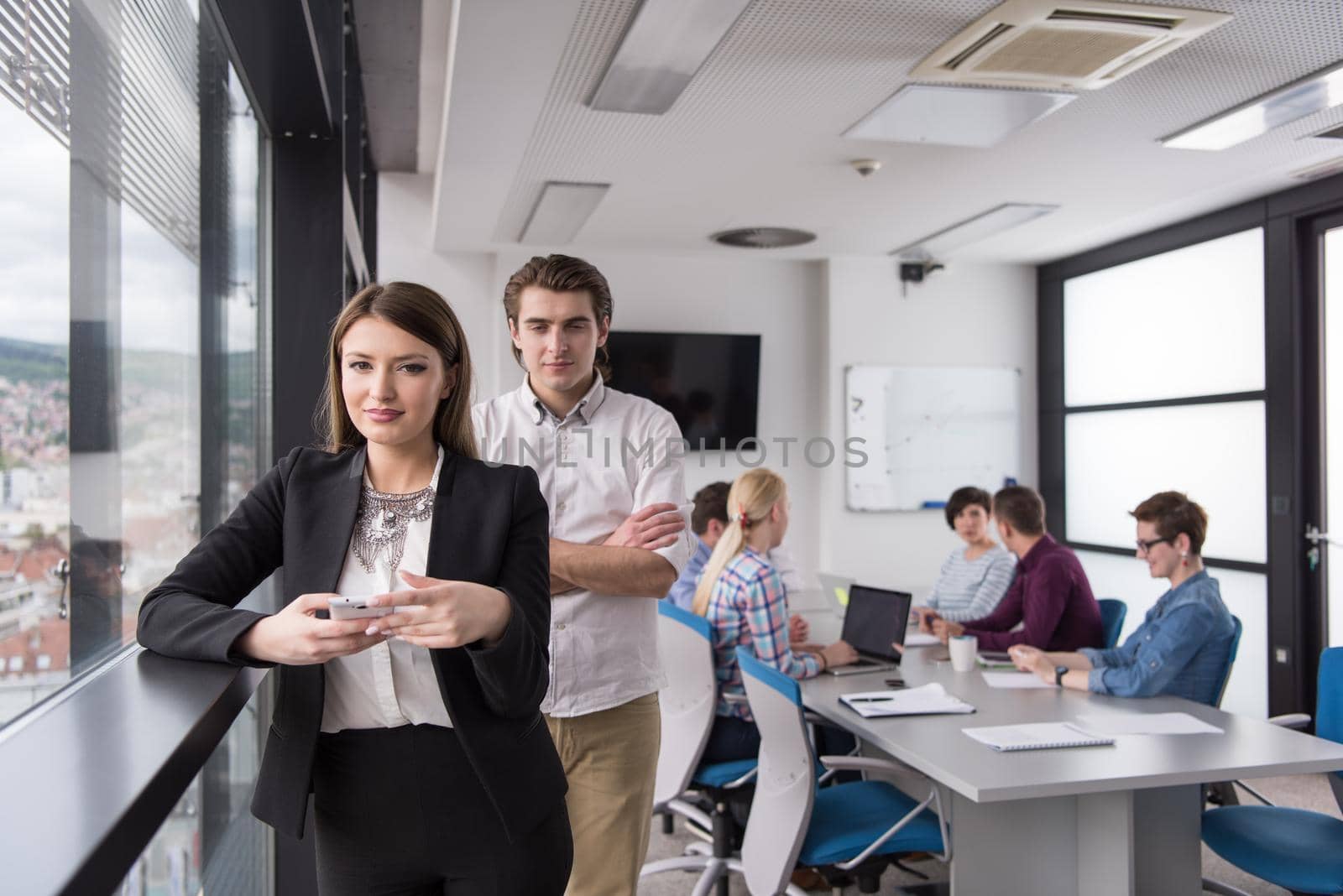 female manager using cell telephone in office interior