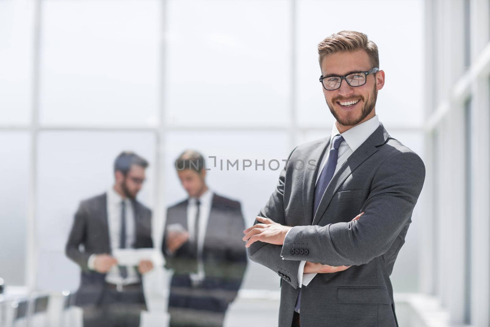 smiling businessman on blurred office background.photo with text space