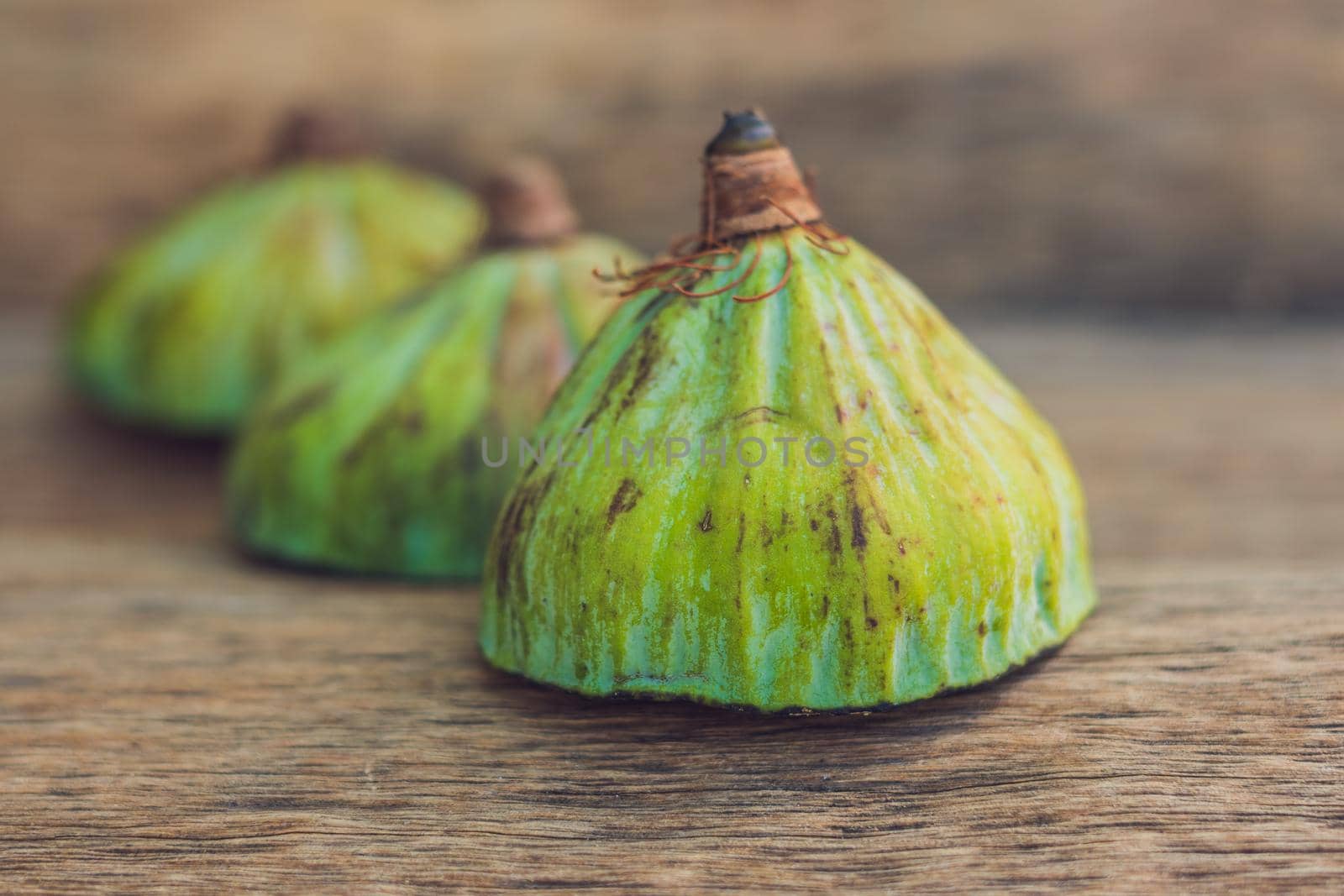 Lotus seeds on an old wooden background by galitskaya