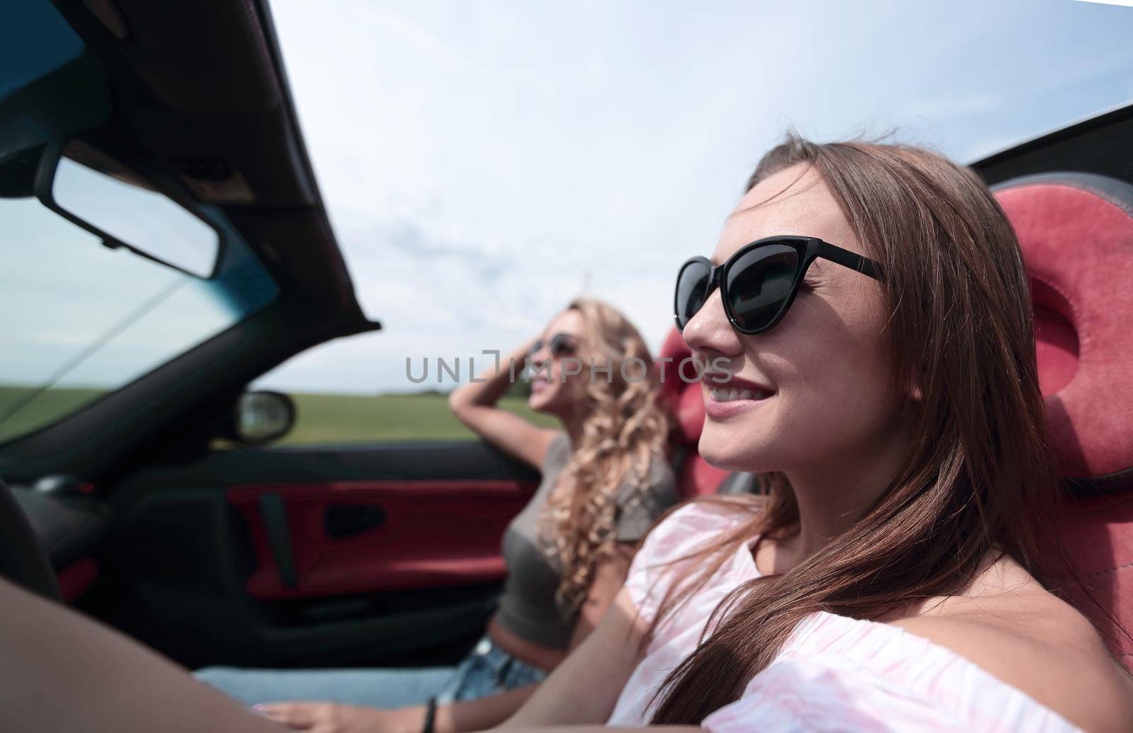 close up.young business woman driving a convertible. by asdf