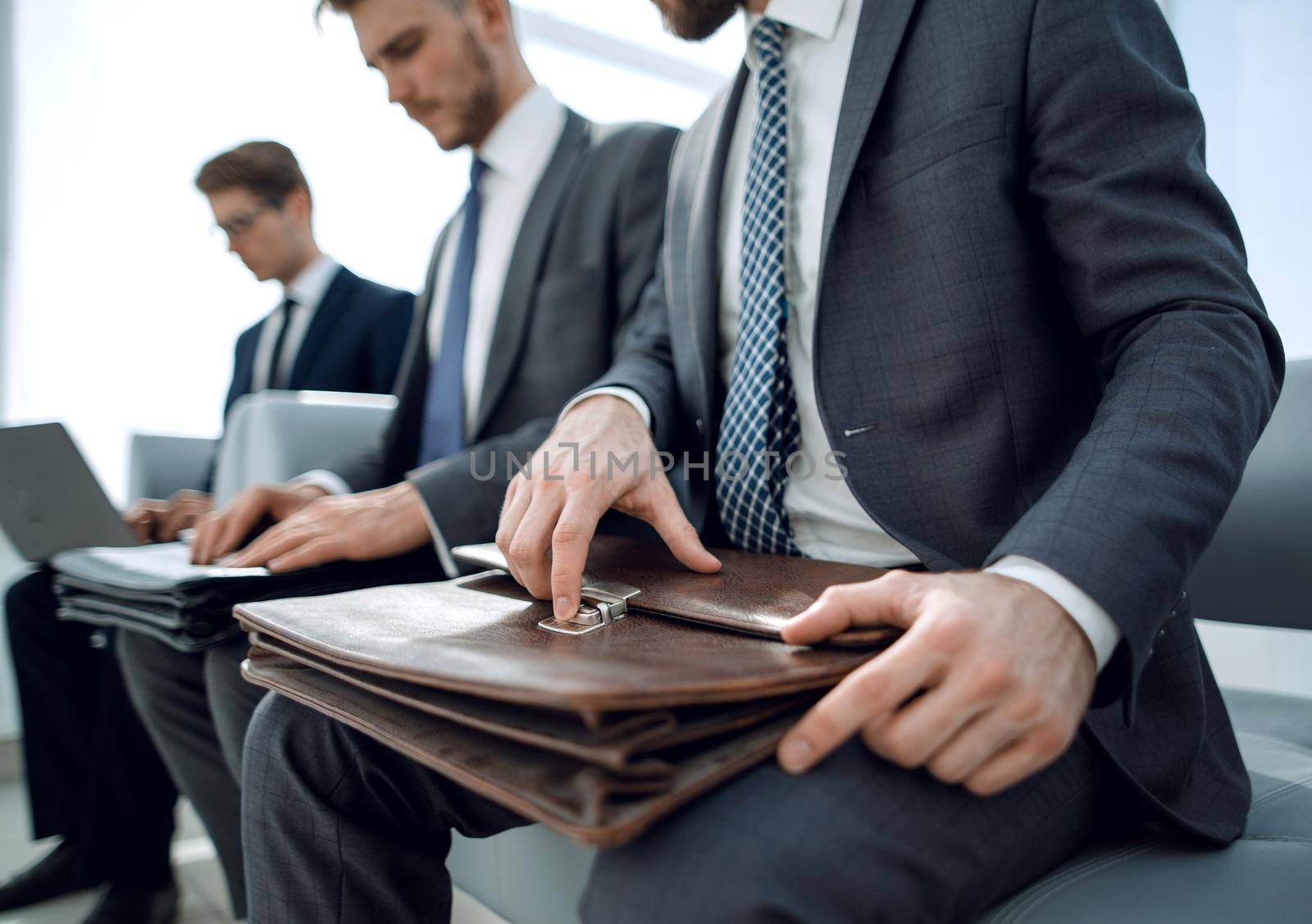 close up.a group of business people sitting in the office waiting room .business concept