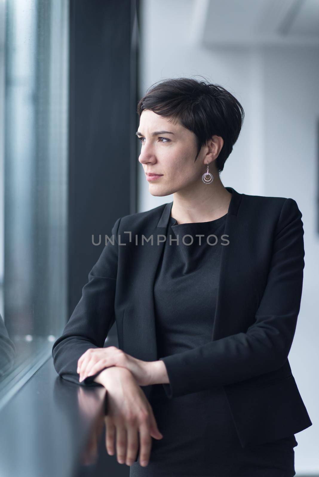Portrait Of Successful Businesswoman by the window Entrepreneur At Busy startup Office