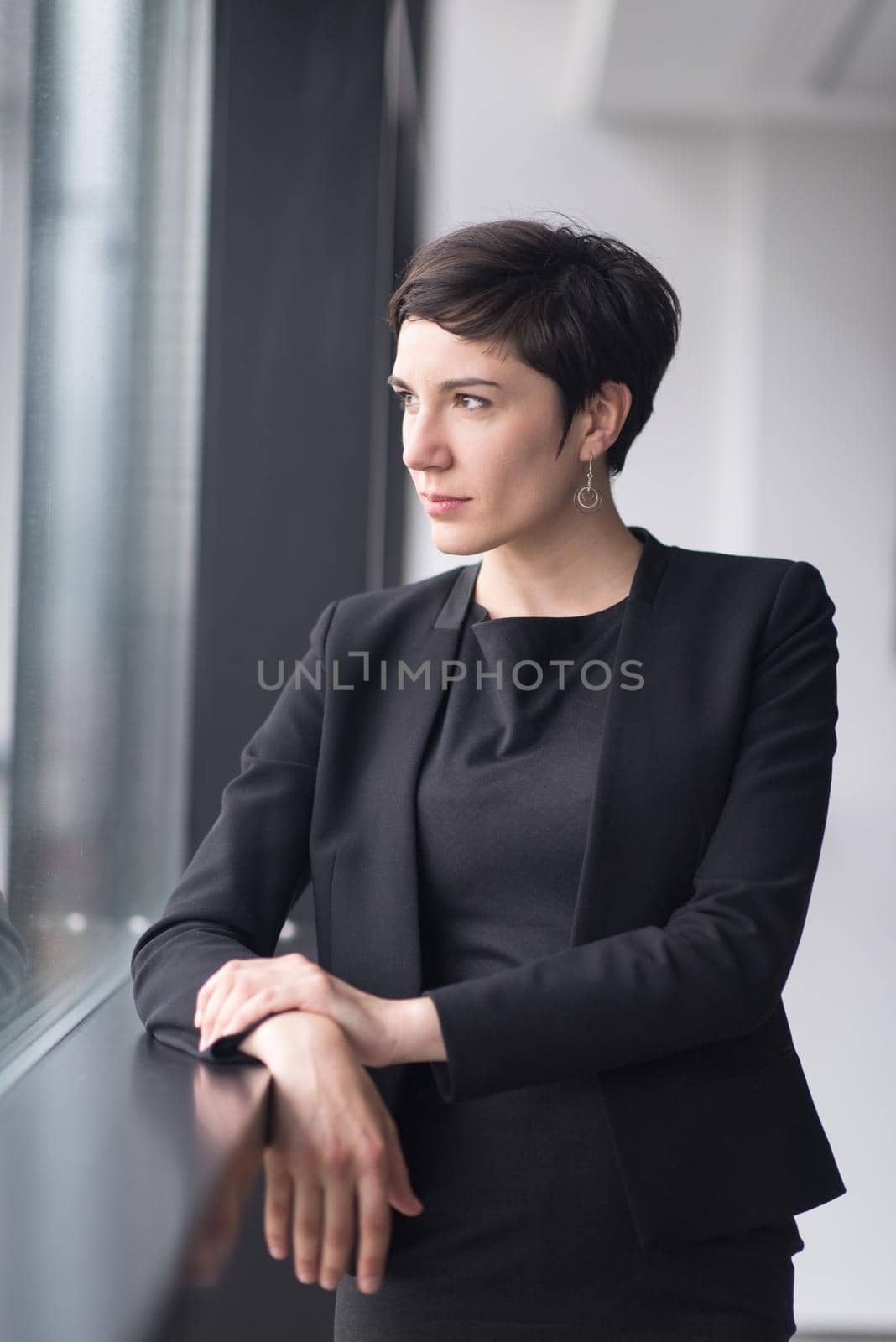 Portrait Of Successful Businesswoman by the window Entrepreneur At Busy startup Office