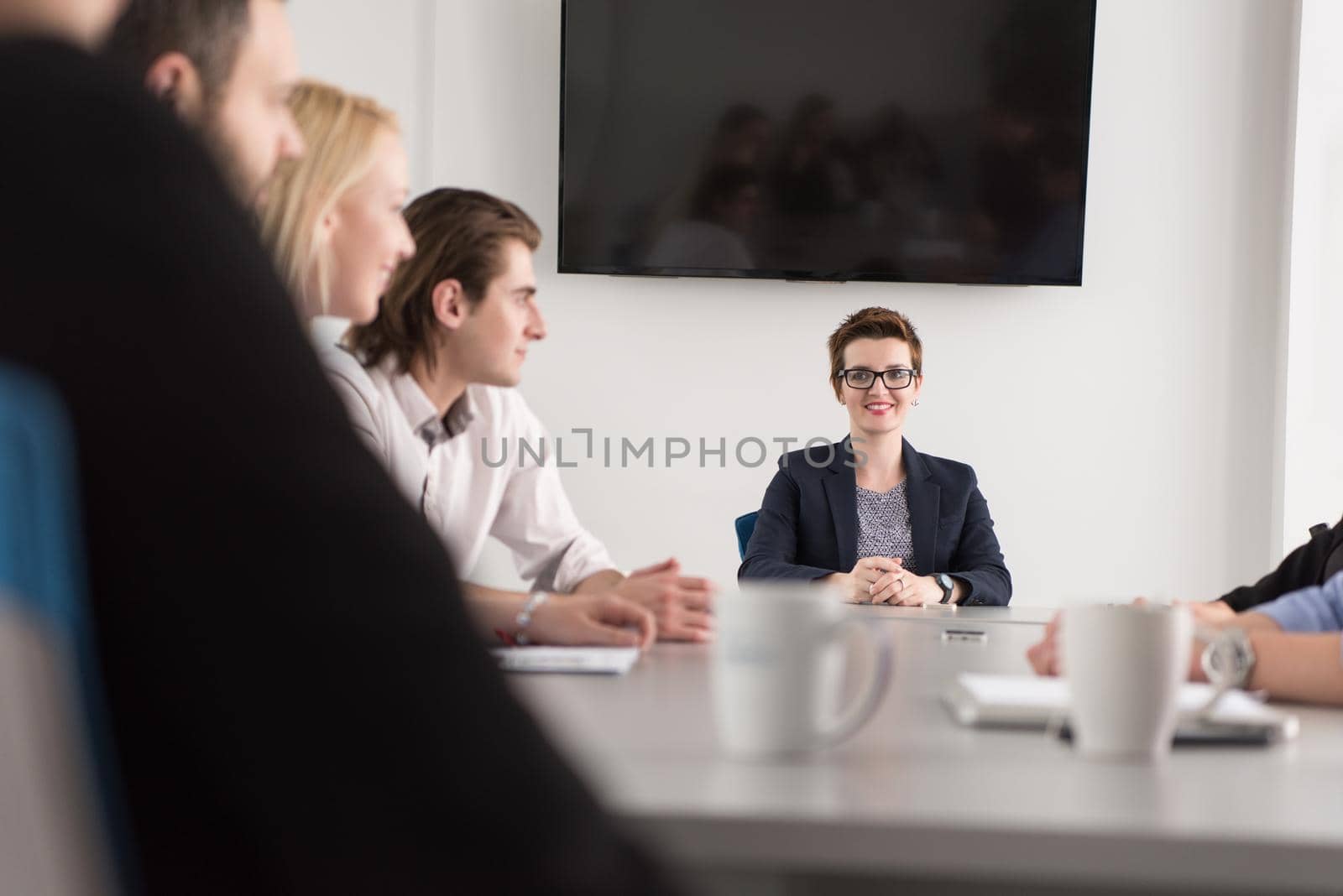 Group of young people meeting in startup office by dotshock