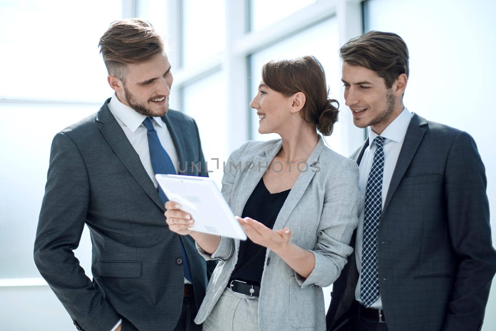 modern business team using tablet computer to work with financial data. people and technology