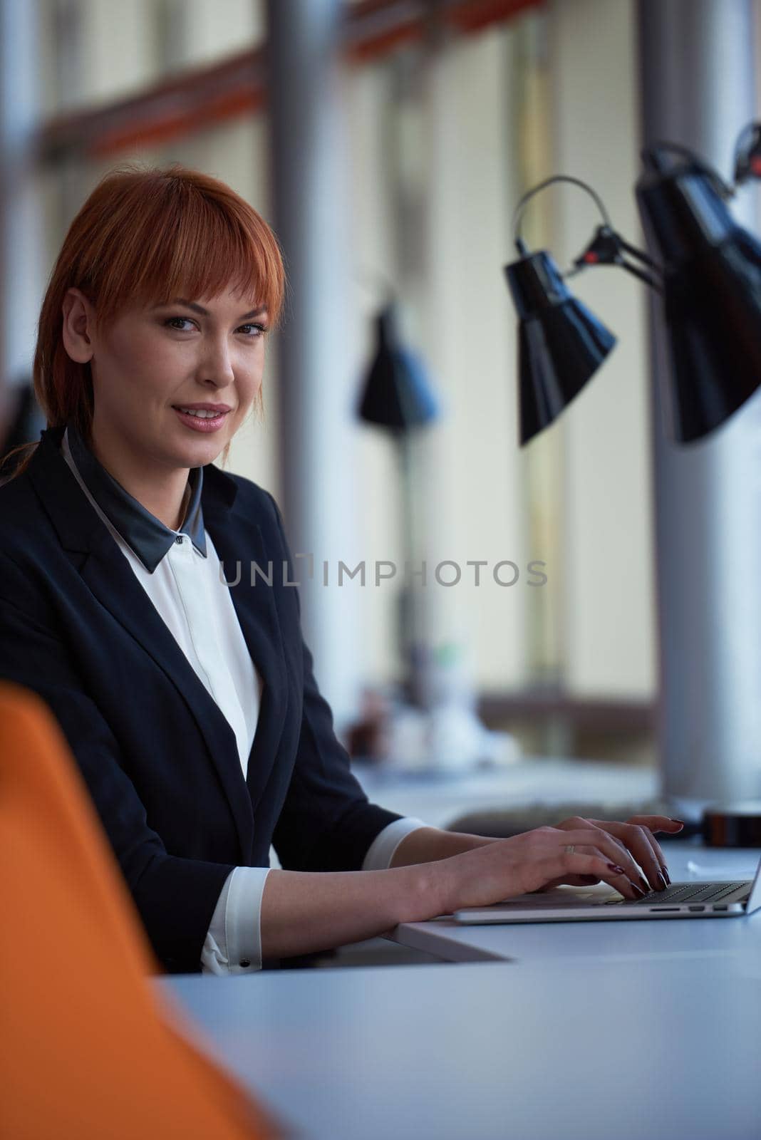 business woman working on computer at office by dotshock