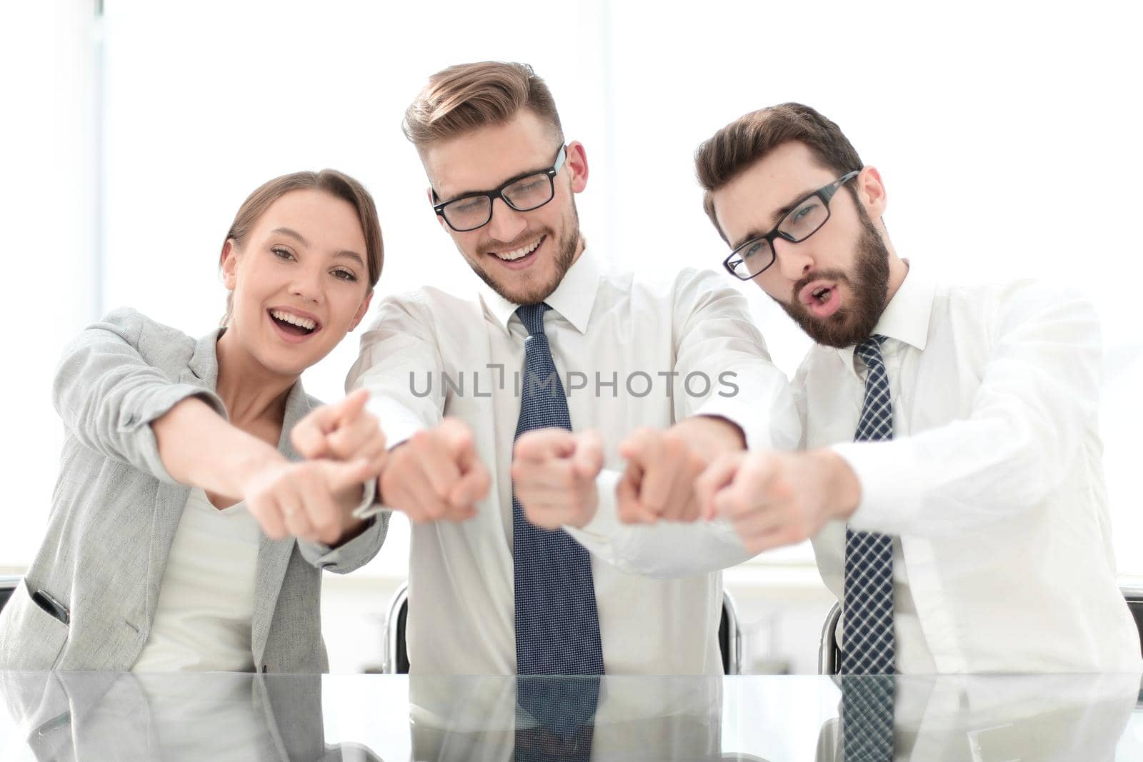 close up.a smiling business team pointing at you.the concept of choice