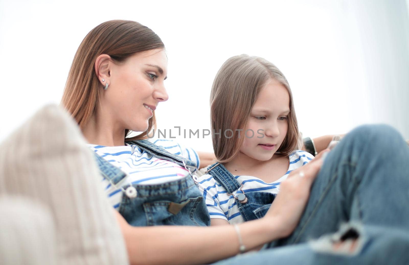 close up.loving young mom and her daughter are relaxing sitting on the couch.photo with copy space