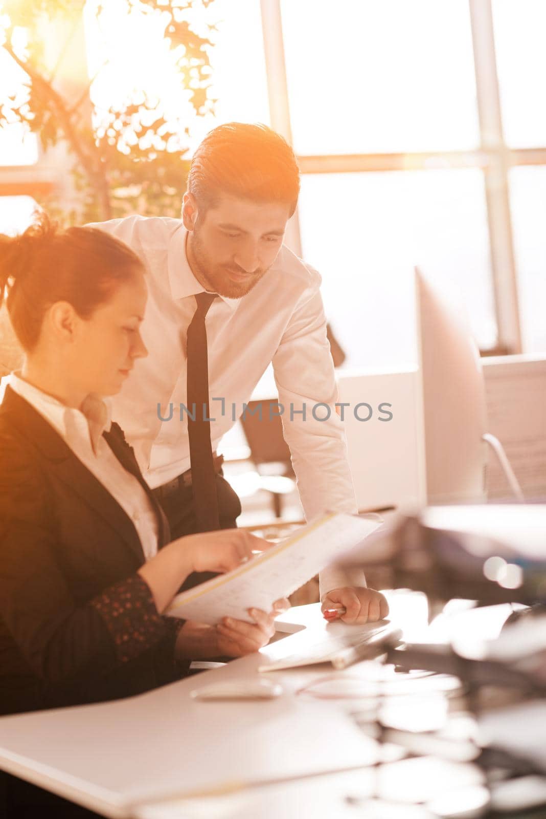 business couple working together on project, sunrise in background by dotshock