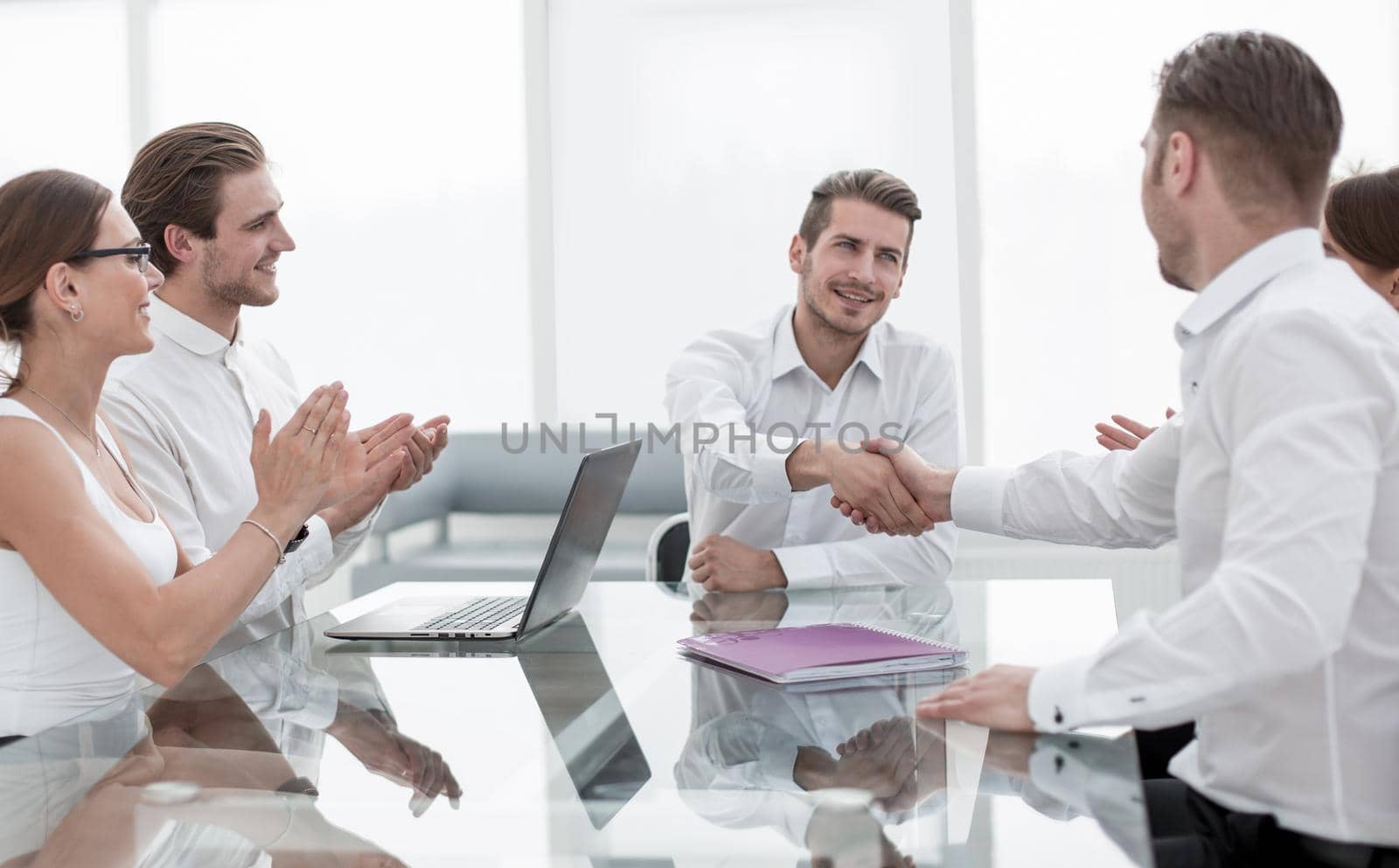 handshake business partners over the Desk.the concept of cooperation