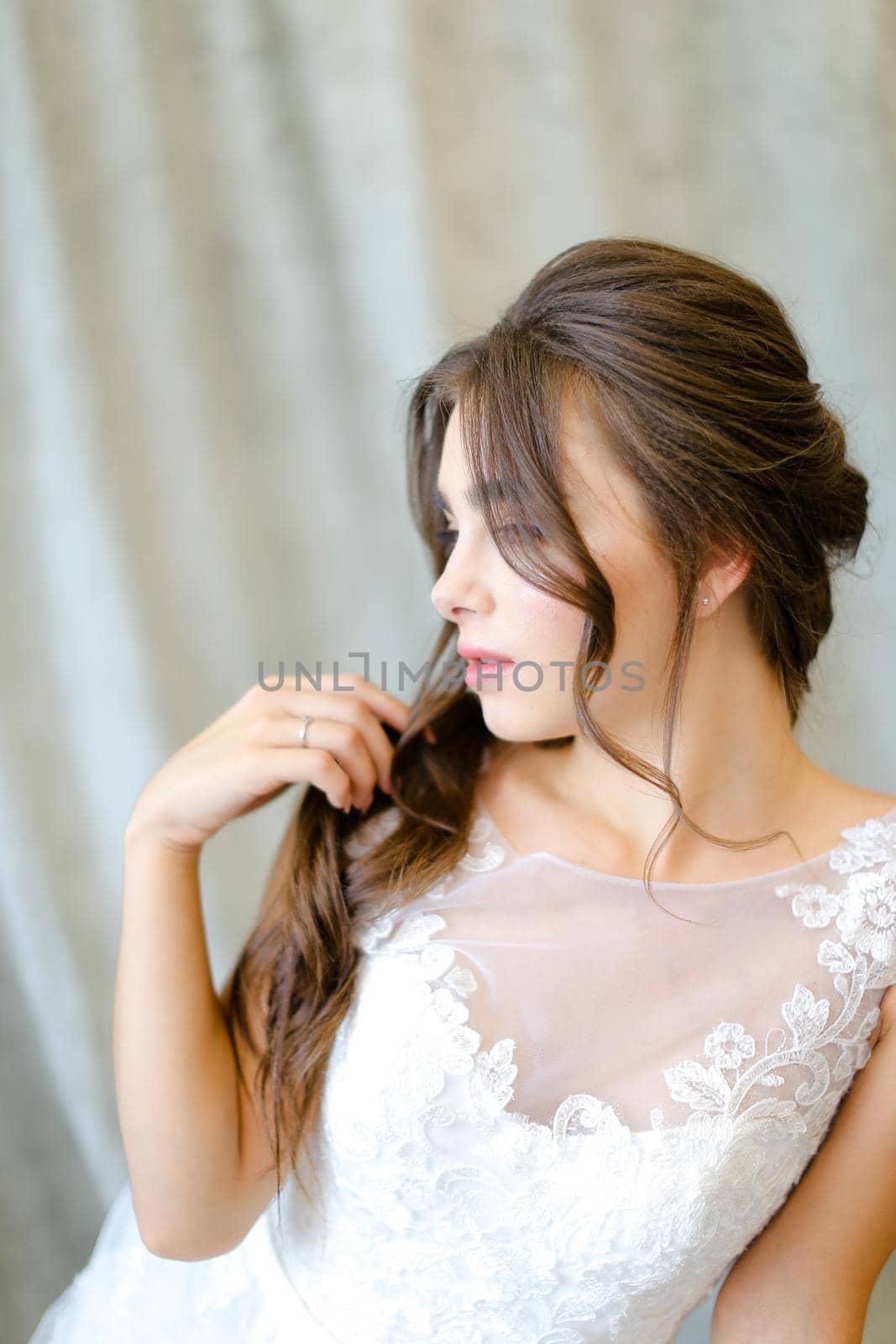 Portrait of young caucasian brunette caucasian bride at studio. Concept of bridal photo session and beauty.