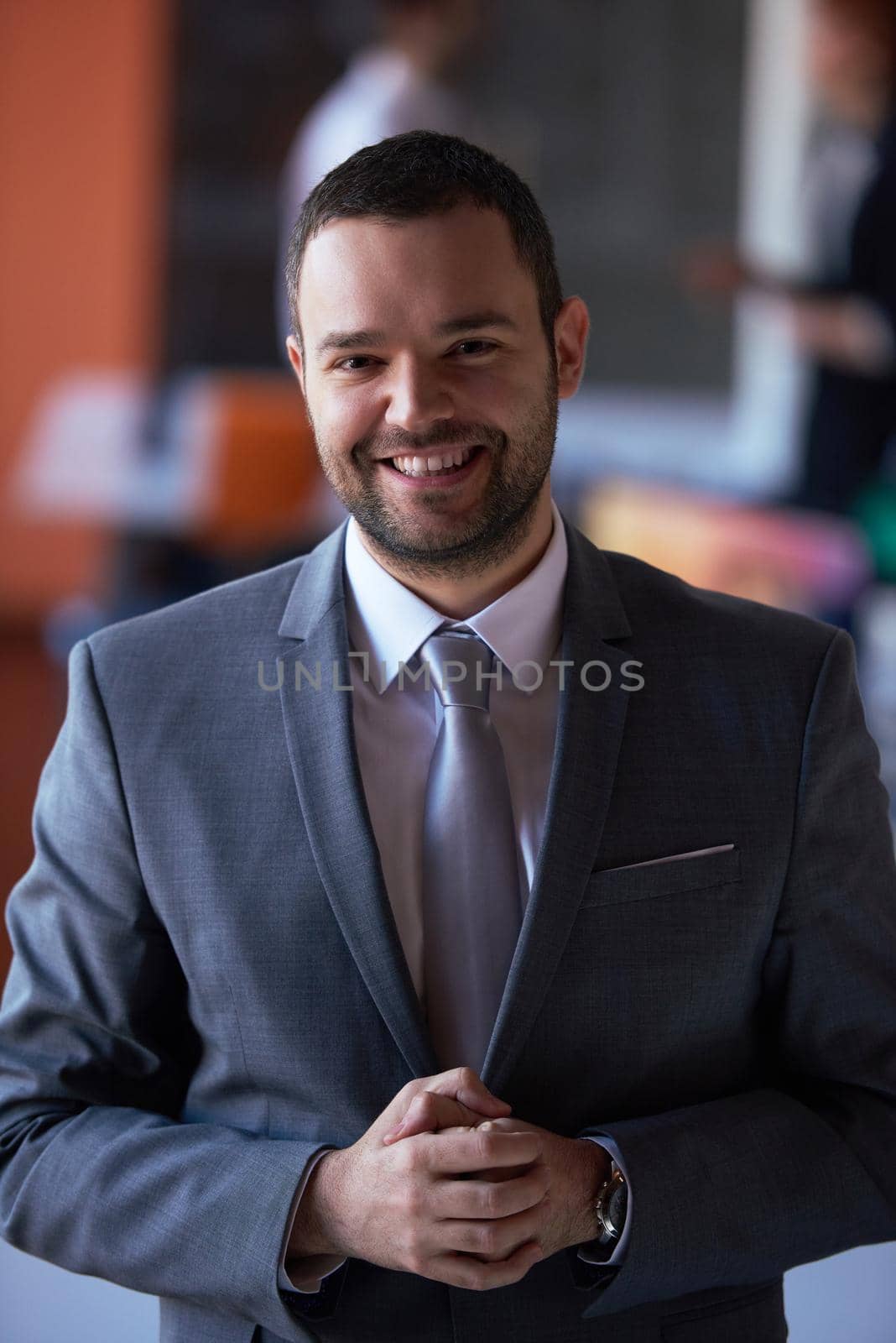 happy young business man portrait  at modern meeting office indoors