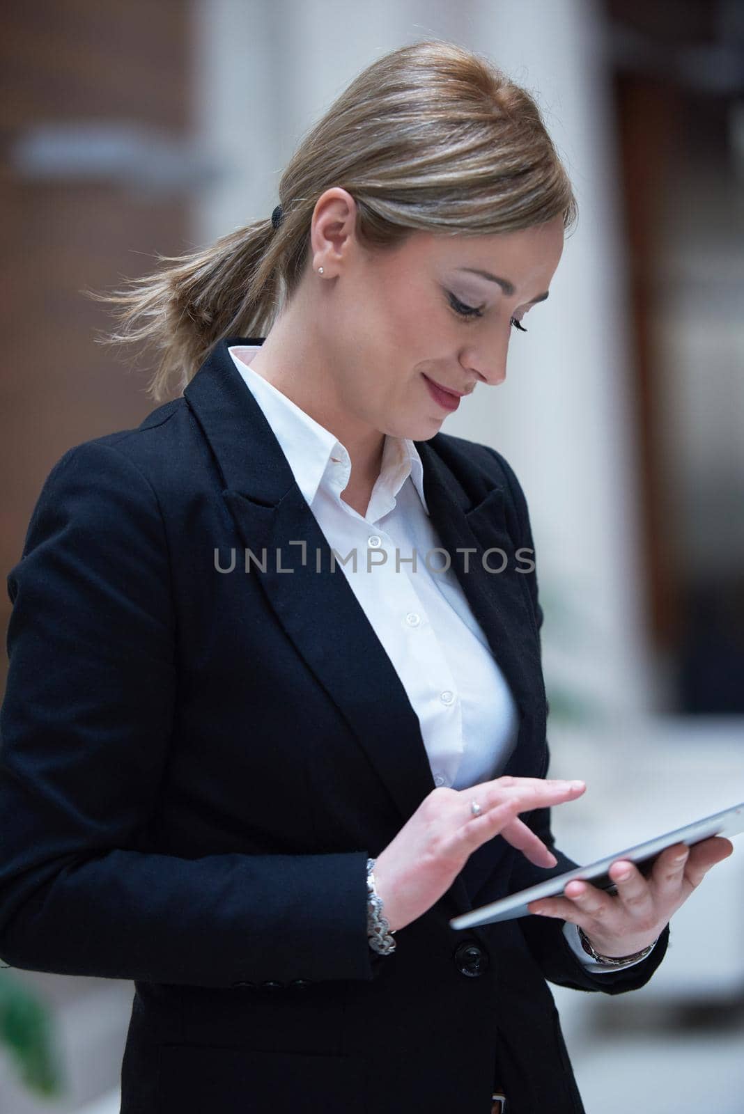 corporate business woman working on tablet computer  at modern office interior