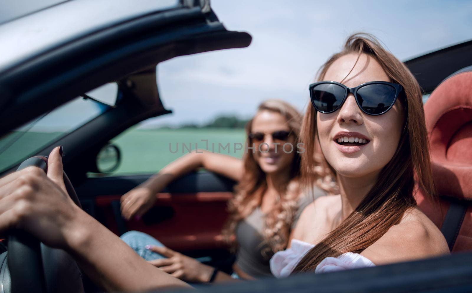 Beautiful woman sitting in cabriolet.fashionable lifestyle concept