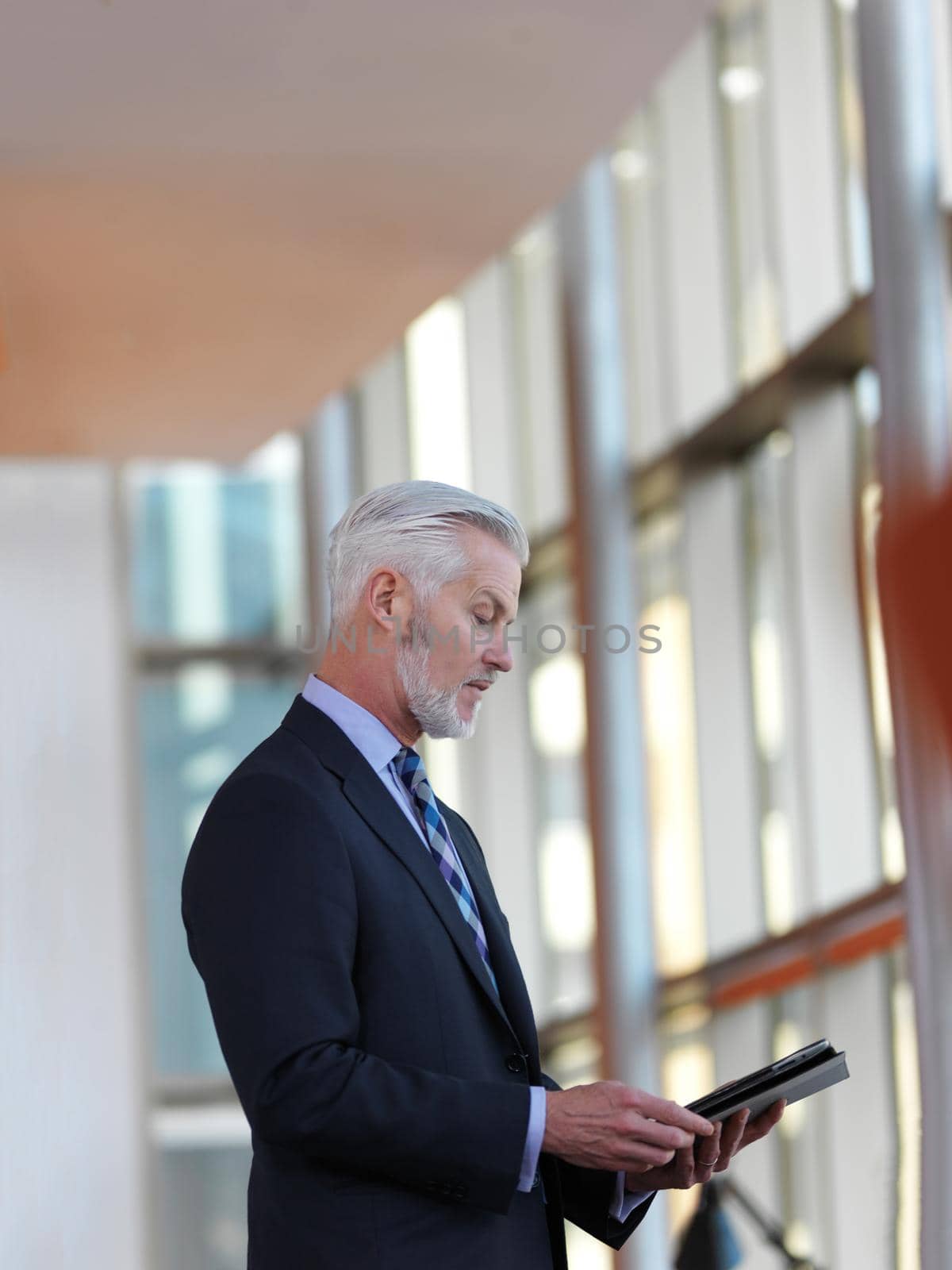 senior business man working on tablet computer at office