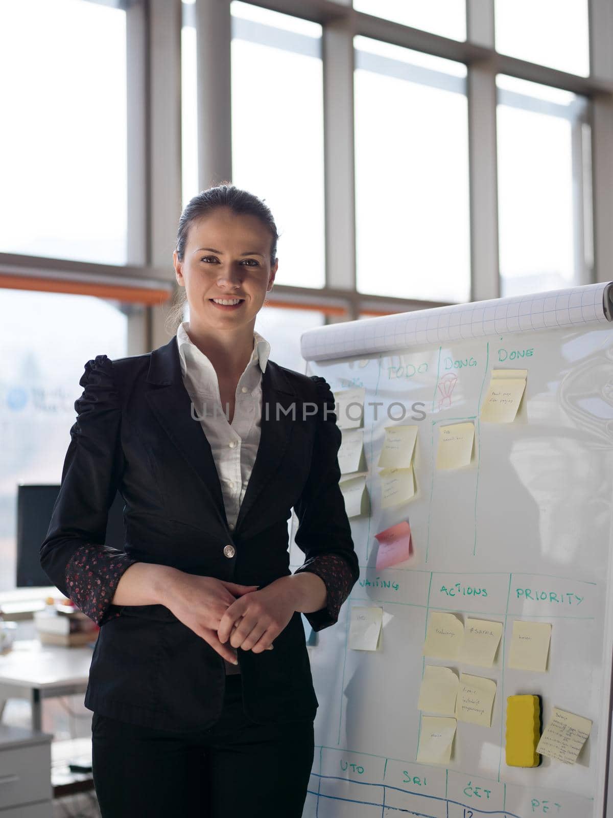 portrait of young business woman at modern office by dotshock